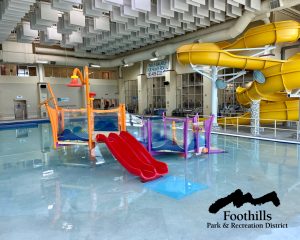 Colorful water play feature in shallow water of the Activity Pool in the Ridge Recreation Center