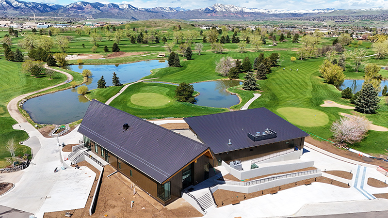 Overhead drone shot of the new Foothills Golf Course Clubhouse building and golf course property in background.