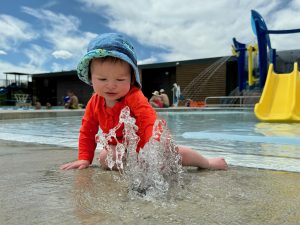 Child playing in spray feature at Columbine West Pool