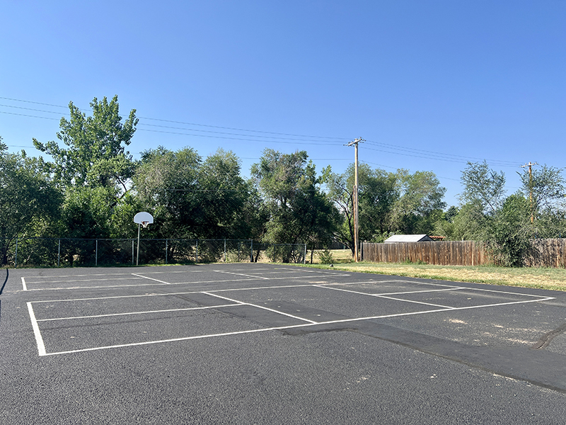 A basketball court with pickleball lines painted on the court for multi-use.