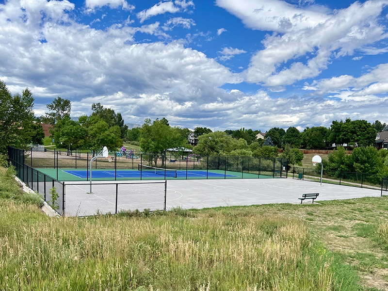 Basketball and tennis courts in a park.