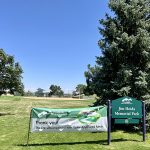 Entry sign for Jim Hoida Memorial Park with the park in the background.