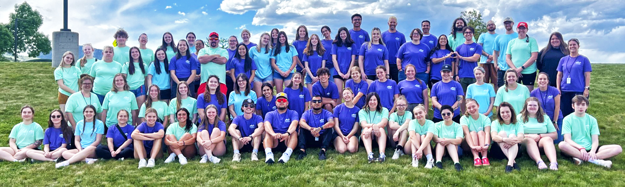 A group of childcare employees smiling and posing together in a group photo.