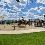 Playground with play features and shade structures.