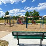 A park bench overlooking a playground.