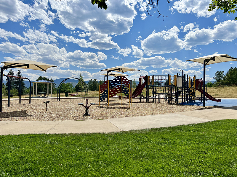 Playground with play features and shade structures.