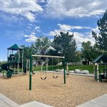 Playground with play tower, slides and swings.