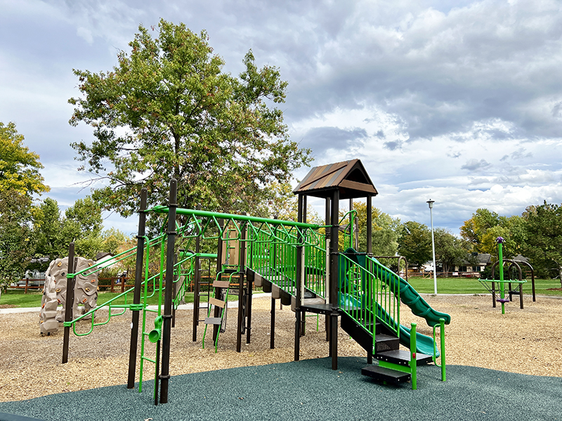 Playground equipment with climbers, slides and play features.